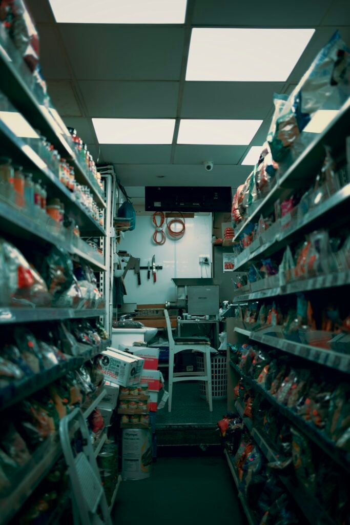 Convenience store aisle stocked with staple goods