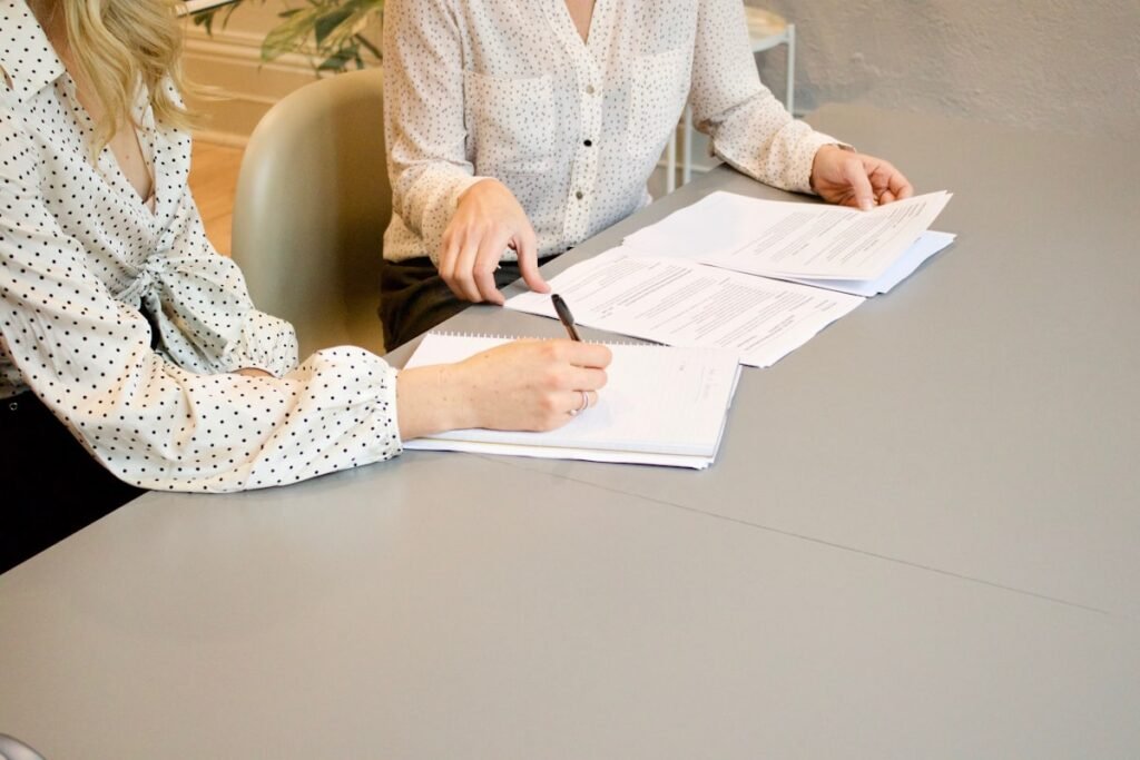 Business owners signing formation paperwork at a desk