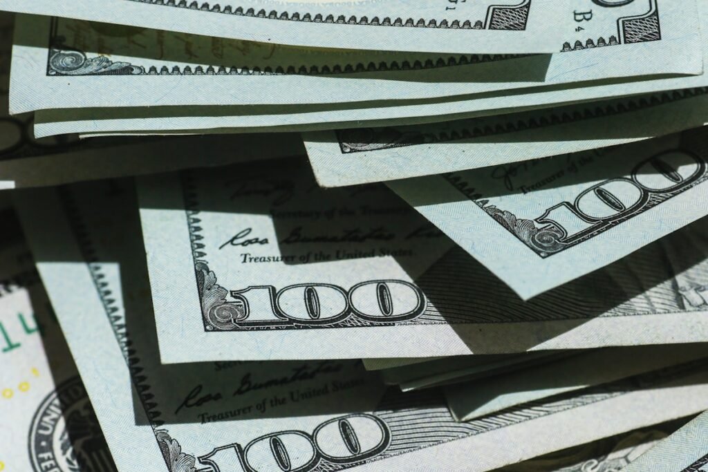 Stacked US hundred-dollar bills, illustrating NJ minimum wage increase