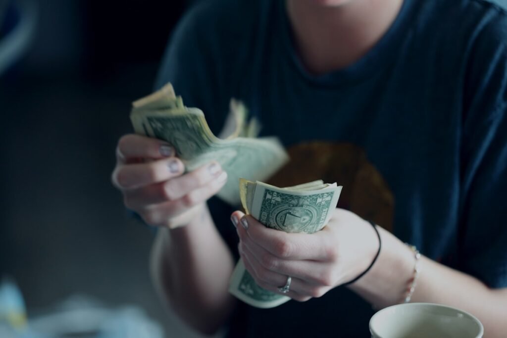 Hands counting US dollar bills, cash payment