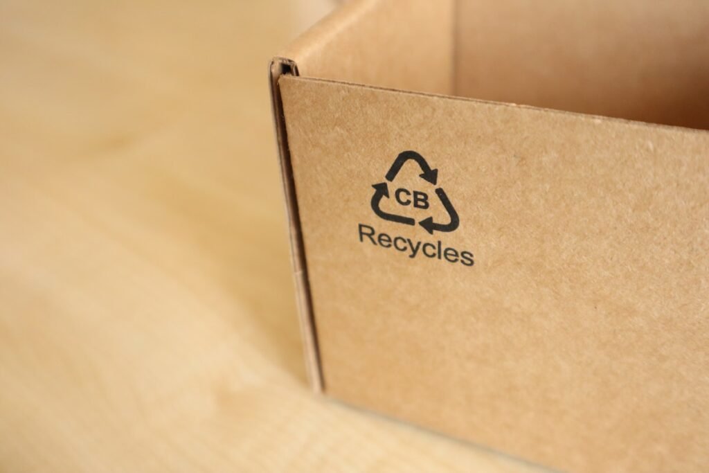 Cardboard shipping box printed with a recycling logo