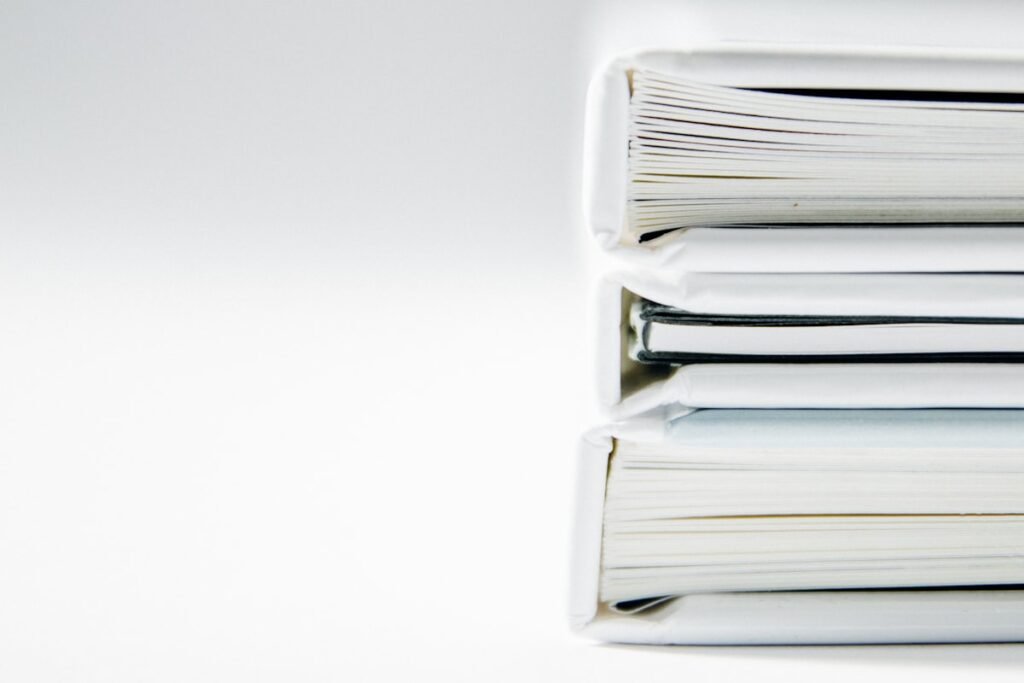 Stack of business document folders representing a state annual report filing