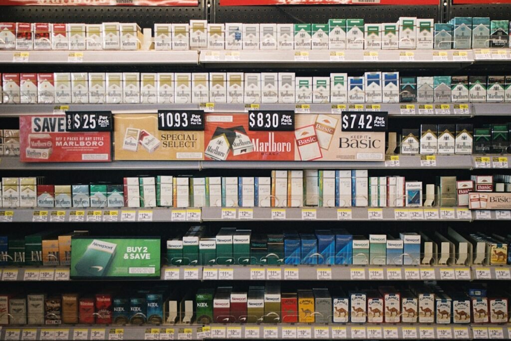 Retail shelf stocked with cigarette brands and price tags