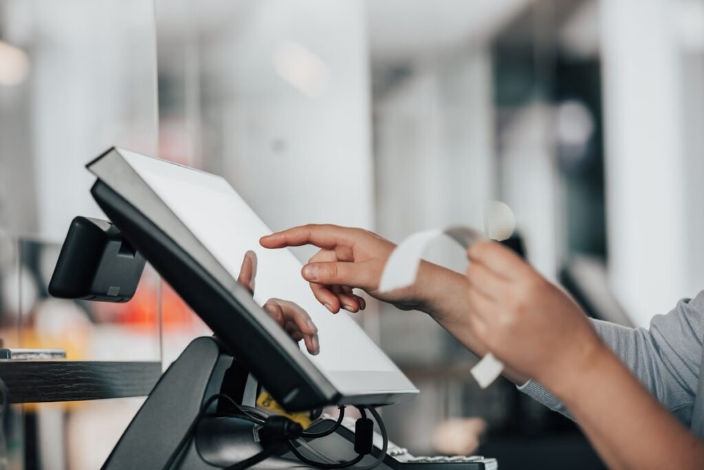 Customer using a point of sale card terminal at a store checkout
