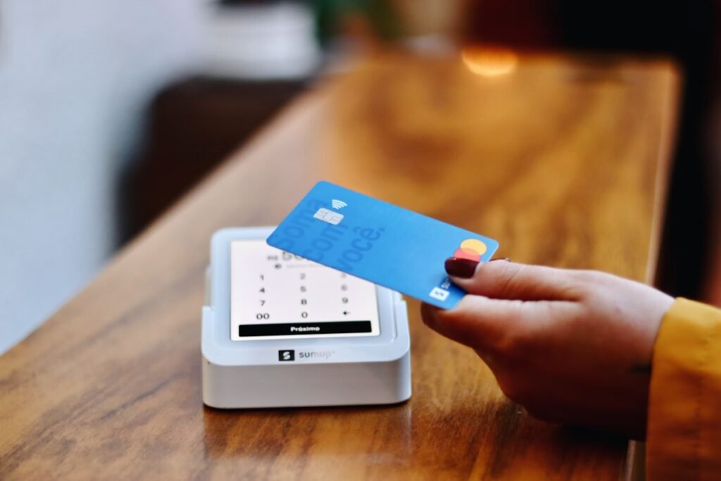 Customer paying with a credit card at a store payment terminal